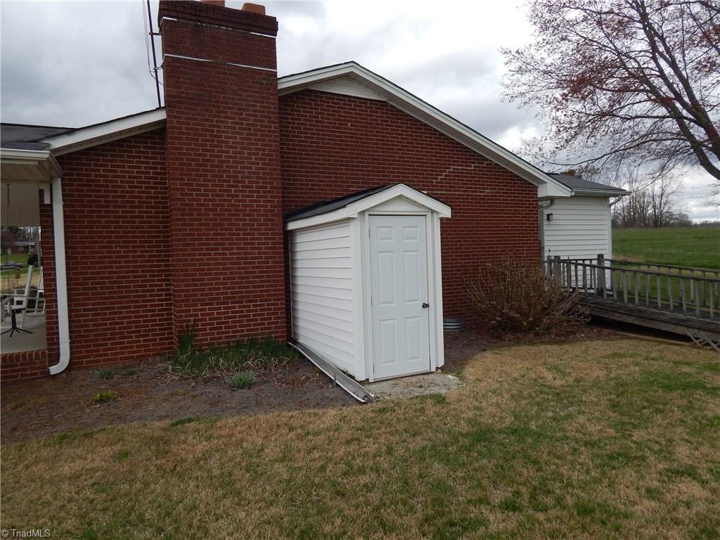 2103 Collinstown Road Westfield, NC 27053 - Photo 23 of 30 Side view of the home shows door that leads into the crawl space and the ramp is still accessible if needed.