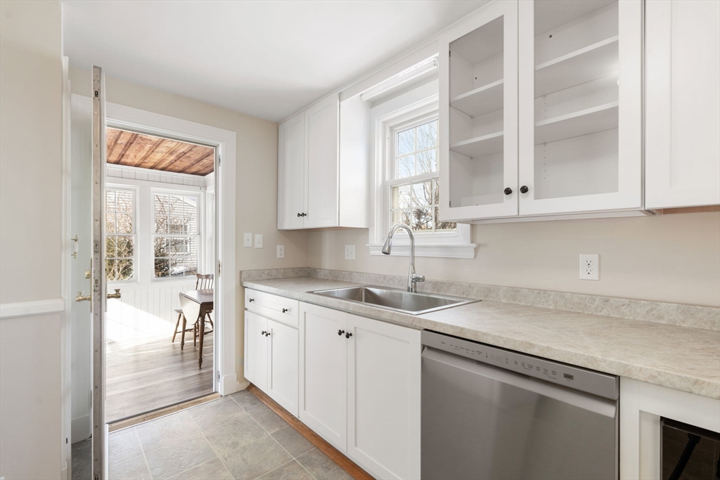 10 MacArthur Circle Peabody, MA 01960 - Photo 4 of 17 a kitchen with stainless steel appliances granite countertop a sink and a white cabinets with wooden floor