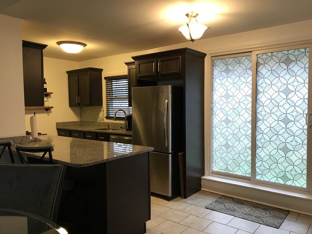 85 Old Farm Road Springfield, MA 01119 - Photo 2 of 14 a kitchen with kitchen island granite countertop a refrigerator and a sink