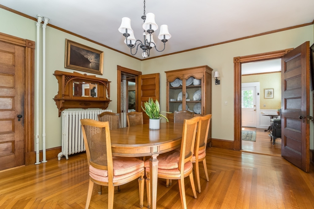 224 Bacon Street Natick, MA 01760 - Photo 13 of 28 a view of a dining room with furniture wooden floor and chandelier