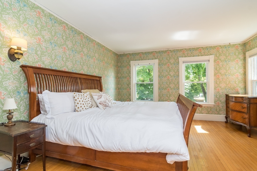224 Bacon Street Natick, MA 01760 - Photo 16 of 28 a bedroom with a bed a table and chair with the wooden floor