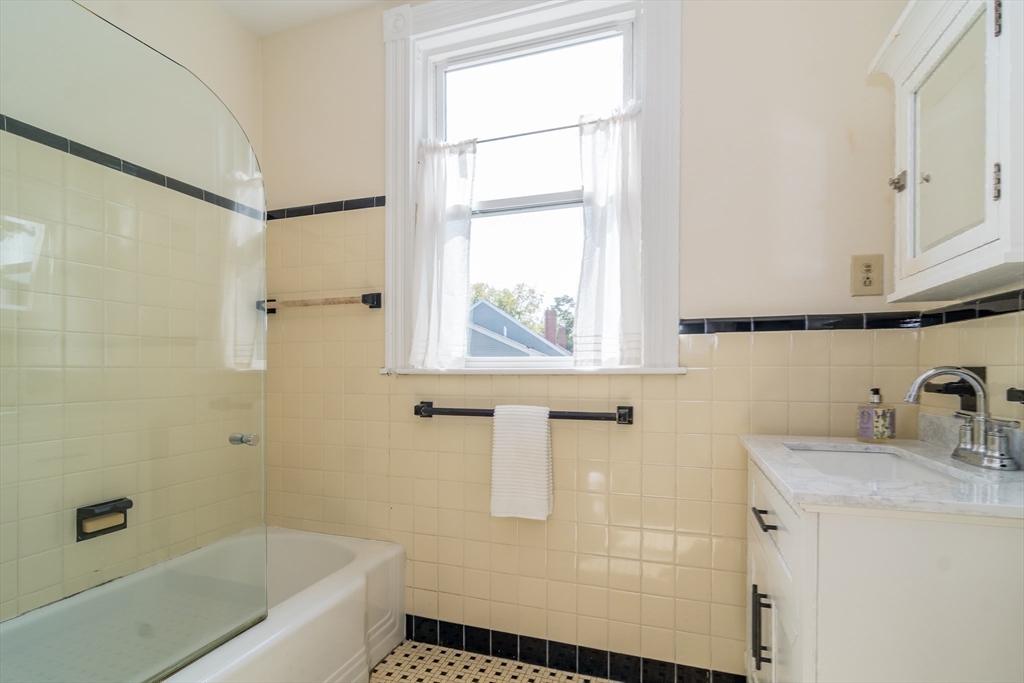 224 Bacon Street Natick, MA 01760 - Photo 18 of 28 a bathroom with a tub sink and mirror