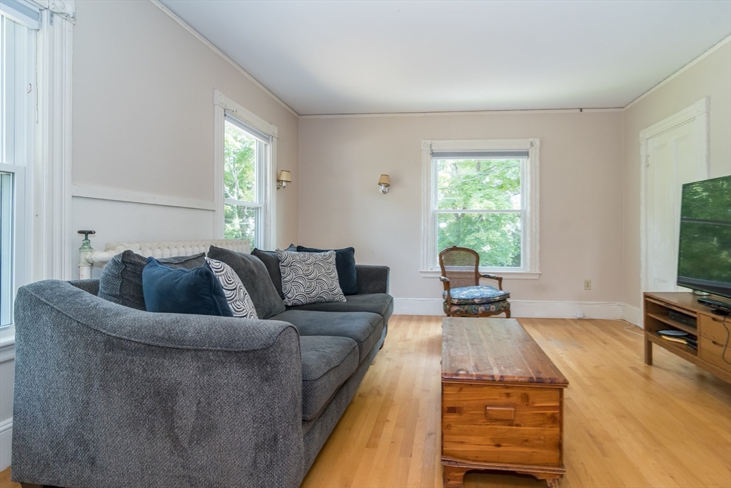224 Bacon Street Natick, MA 01760 - Photo 19 of 28 a living room with furniture or couch and a flat tv screen next to a window