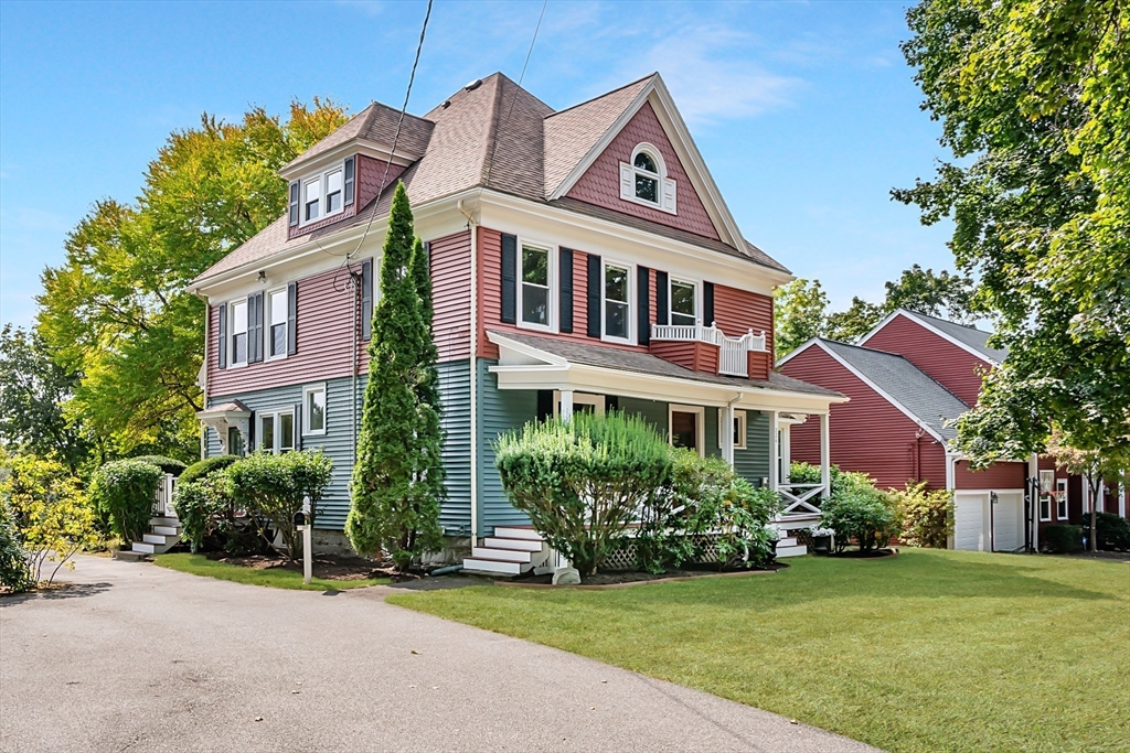 224 Bacon Street Natick, MA 01760 - Photo 2 of 28 a front view of a house with a garden