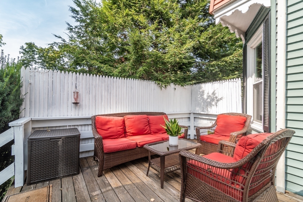 224 Bacon Street Natick, MA 01760 - Photo 27 of 28 a outdoor sitting area with a couch and a potted plant
