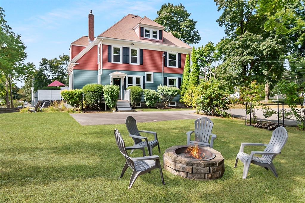 224 Bacon Street Natick, MA 01760 - Photo 3 of 28 a brick house with table and chairs in front of it