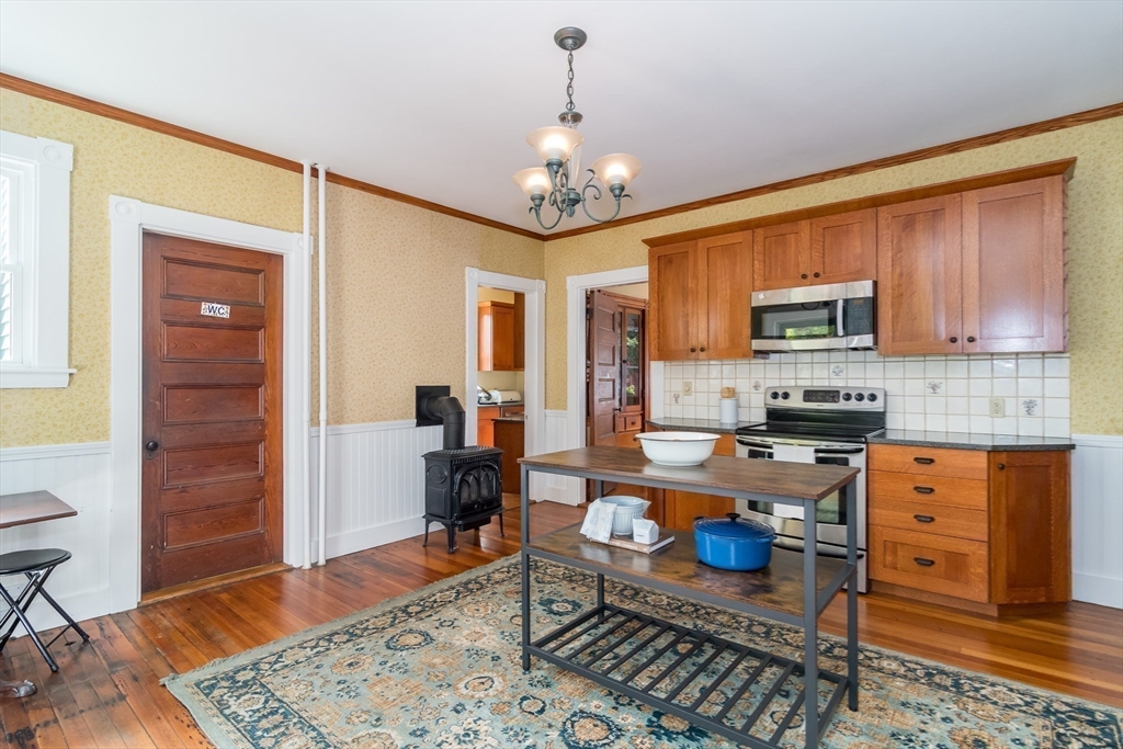 224 Bacon Street Natick, MA 01760 - Photo 10 of 28 a kitchen with stainless steel appliances granite countertop a stove top oven a sink dishwasher and cabinets with wooden floor