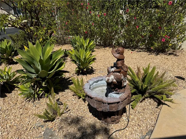 a vase of flowers sitting on a table with wooden floor