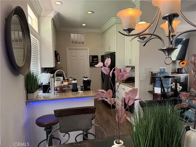 a view of gym equipment and a chandelier