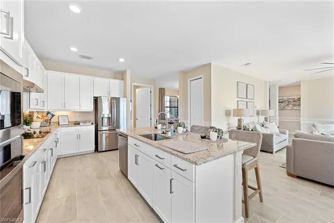 a large white kitchen with cabinets and stainless steel appliances
