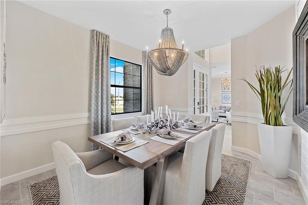 11581 Timber Creek Drive Fort Myers, FL 33913 - Photo 15 of 50 a dining room with furniture a chandelier and wooden floor