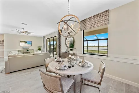 a dining room with furniture a chandelier and wooden floor