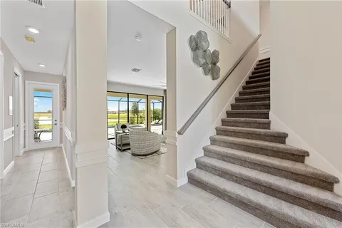 a dining room with furniture and a mirror