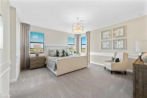 a view of a livingroom with furniture a chandelier and wooden floor