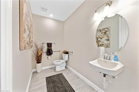 a spacious bathroom with a granite countertop tub sink and mirror