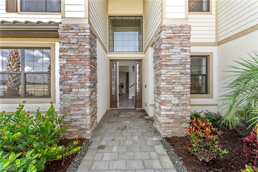 11581 Timber Creek Drive Fort Myers, FL 33913 - Photo 3 of 50 a view of the front door of a house with potted plants