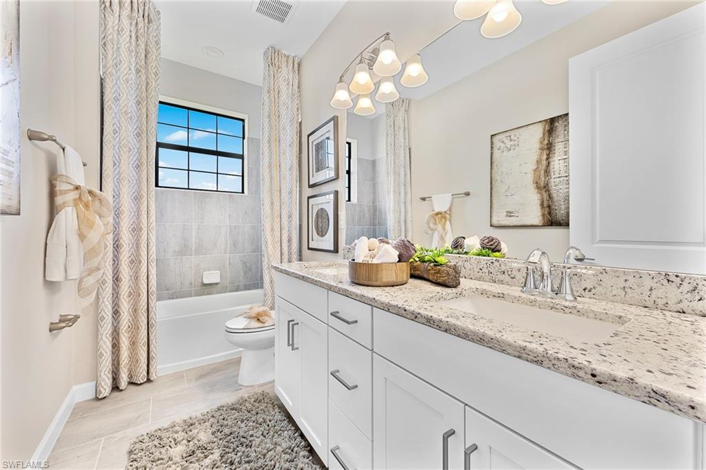 11581 Timber Creek Drive Fort Myers, FL 33913 - Photo 32 of 50 a bathroom with a granite countertop sink a toilet and a large mirror