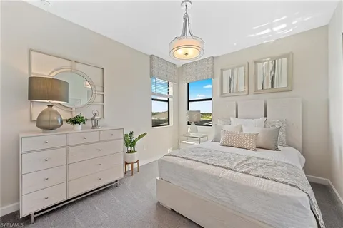 a bathroom with a granite countertop sink a toilet and a large mirror