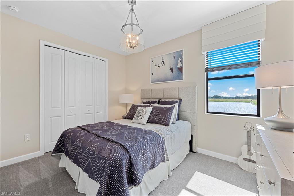 11581 Timber Creek Drive Fort Myers, FL 33913 - Photo 35 of 50 a bedroom with a bed and a chandelier