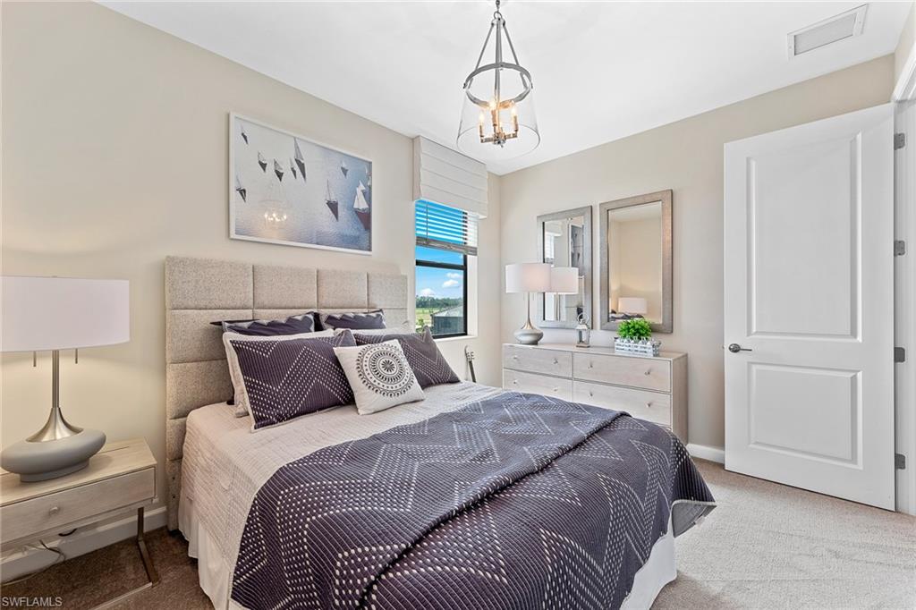 11581 Timber Creek Drive Fort Myers, FL 33913 - Photo 36 of 50 a bedroom with a bed and wooden floor