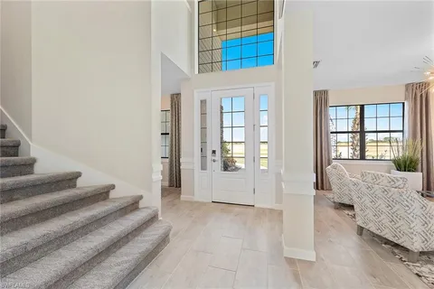 a spacious bedroom with a bed and glass door