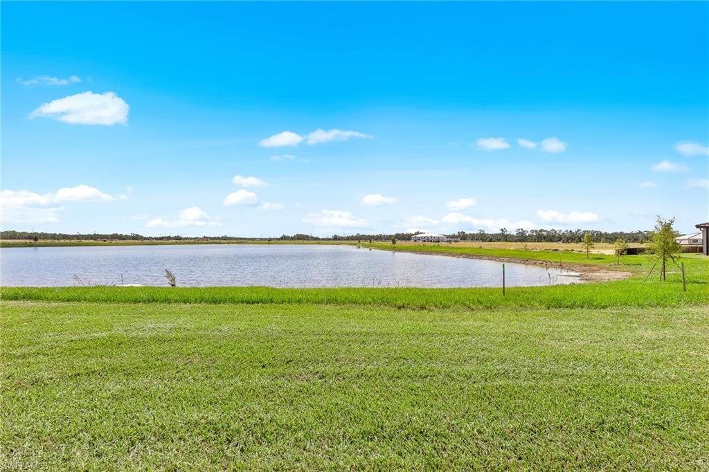 11581 Timber Creek Drive Fort Myers, FL 33913 - Photo 43 of 50 a view of a lake and a yard