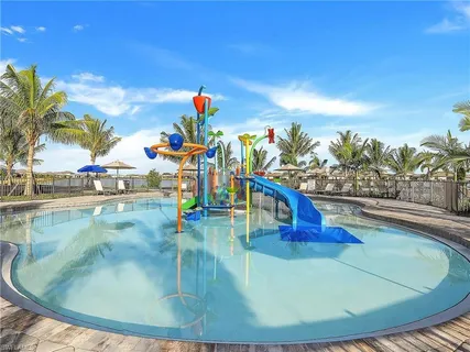 a view of an outdoor space with swimming pool and seating