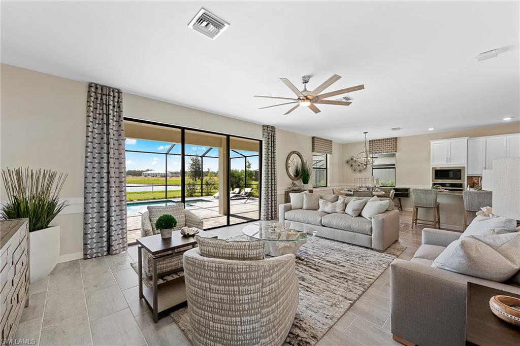 11581 Timber Creek Drive Fort Myers, FL 33913 - Photo 5 of 50 a living room with furniture floor to ceiling window and a potted plant