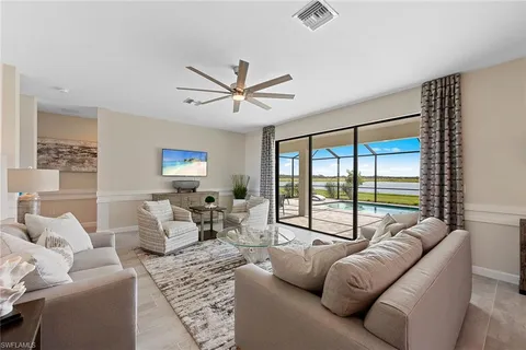 a living room with furniture and a large window