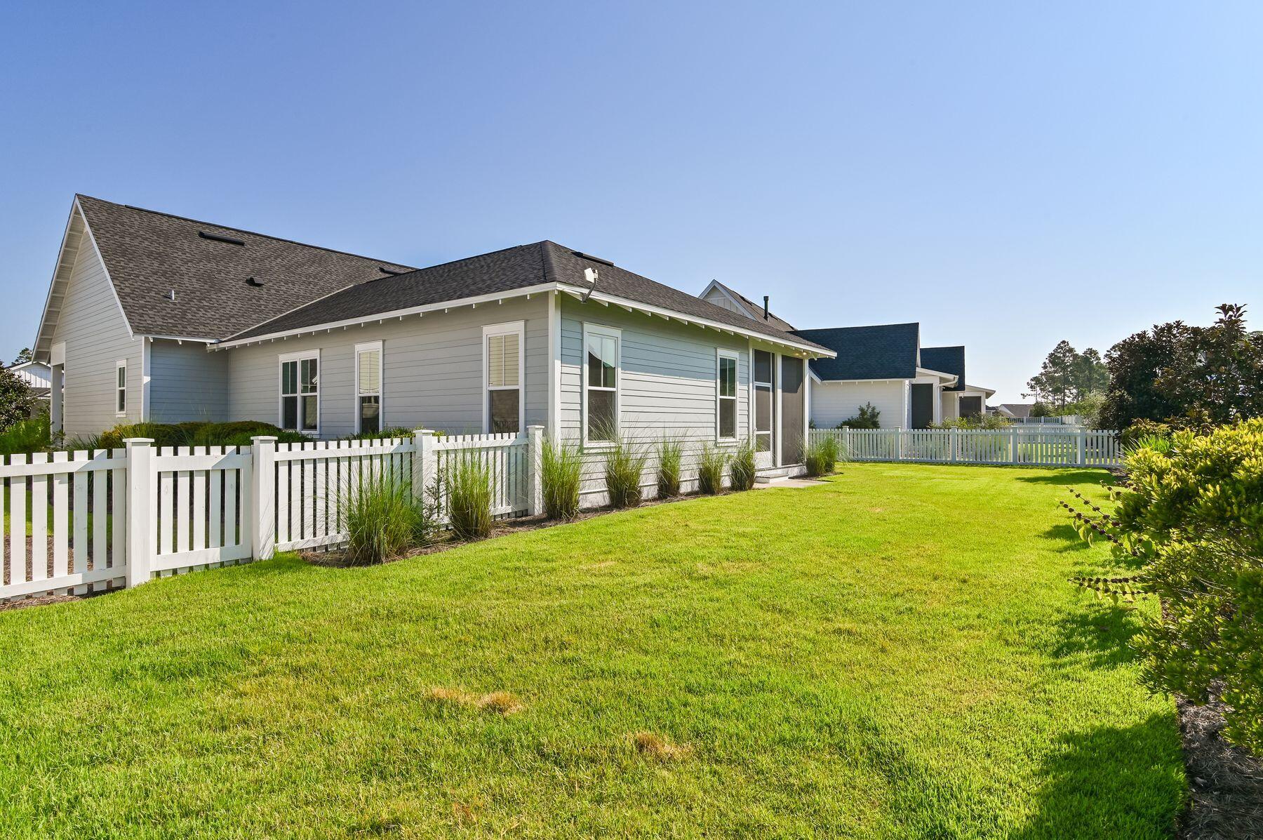 82 Sidecamp Road Watersound, FL 32461 - Photo 12 of 32 a front view of a house with a garden