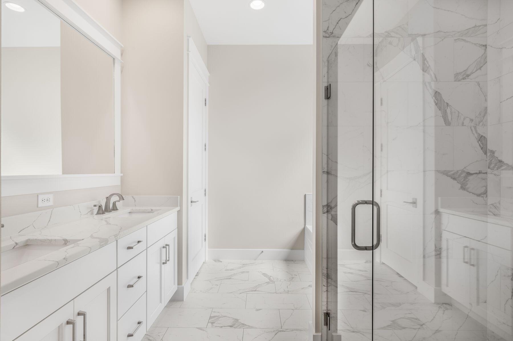 82 Sidecamp Road Watersound, FL 32461 - Photo 17 of 32 a bathroom with a double vanity sink a and a shower