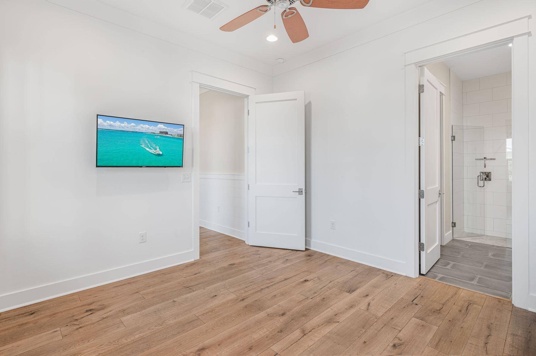 82 Sidecamp Road Watersound, FL 32461 - Photo 22 of 32 a view of an empty room with wooden floor