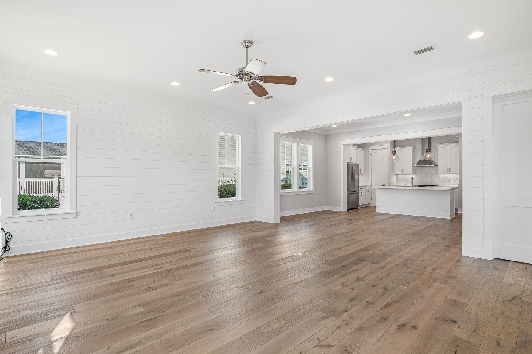 82 Sidecamp Road Watersound, FL 32461 - Photo 9 of 32 a view of an empty room with wooden floor and a window