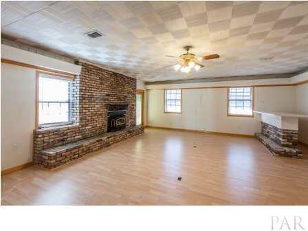 150 Balboa Road Cantonment, FL 32533 - Photo 13 of 25 Cozy up to the fireplace in the Den and enjoy a drink from the bar