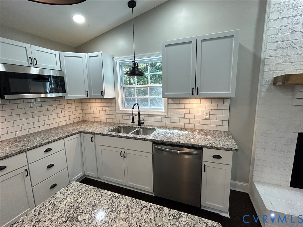 1024 Mill Road King William, VA 23086 - Photo 9 of 35 a kitchen with granite countertop a sink and cabinets