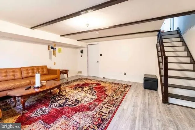a living room with furniture and a rug