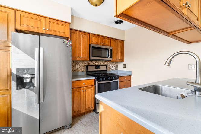 7521 Valley Avenue Philadelphia, PA 19128 - Photo 7 of 14 a kitchen with stainless steel appliances granite countertop a refrigerator and a stove top oven