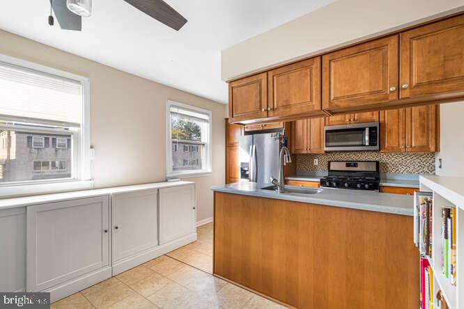 7521 Valley Avenue Philadelphia, PA 19128 - Photo 8 of 14 a kitchen with stainless steel appliances a sink cabinets and a window