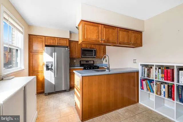 a kitchen with stainless steel appliances a refrigerator and a cabinets