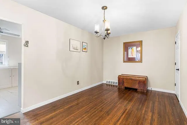 a view of room with hardwood flooring and ceiling fan