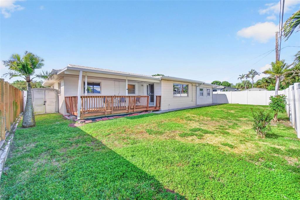 11225 59th Avenue Seminole, FL 33772 - Photo 12 of 15 a view of a house with a backyard and a patio
