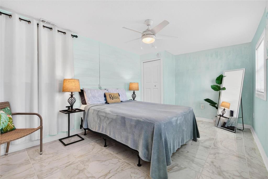 11225 59th Avenue Seminole, FL 33772 - Photo 7 of 15 a bedroom with bed and a chandelier