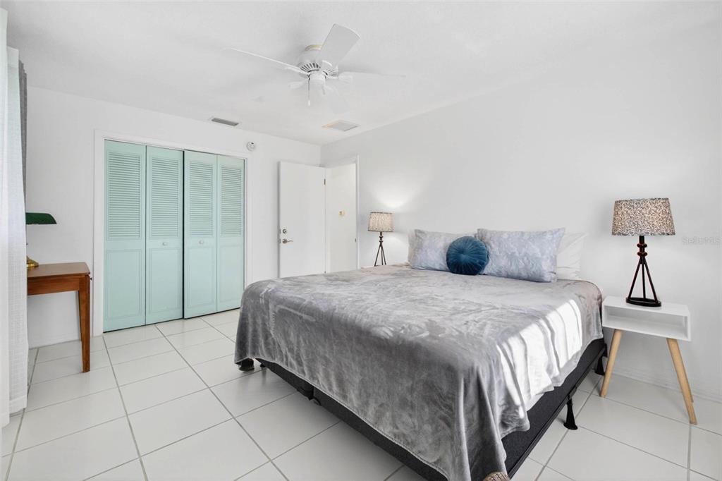 11225 59th Avenue Seminole, FL 33772 - Photo 9 of 15 a bedroom with a bed and a chandelier