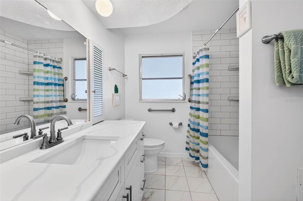 11225 59th Avenue Seminole, FL 33772 - Photo 10 of 15 a bathroom with a sink toilet and shower
