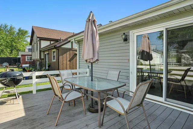 a balcony with table and chairs