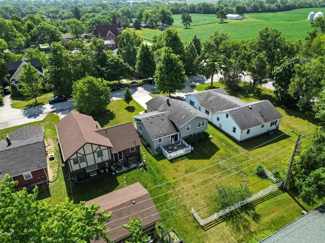 an aerial view of a house with garden space and street view