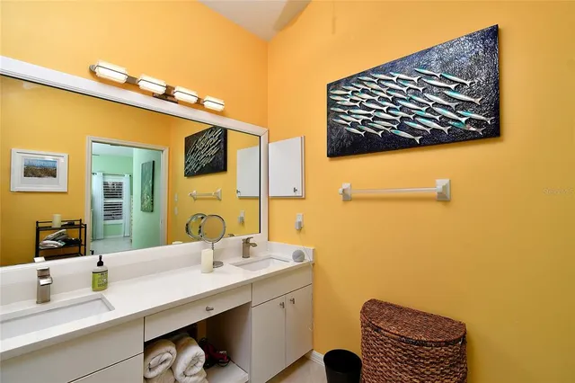 a bathroom with a sink a mirror and shower curtain