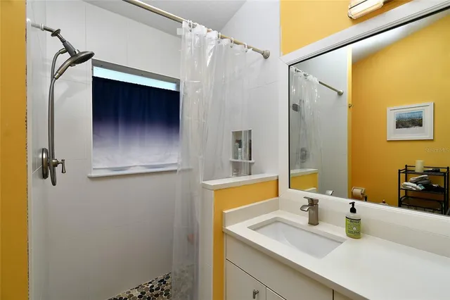 a bathroom with a sink and mirror