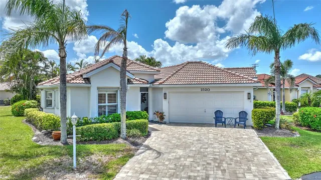 a view of a house with a yard and plants