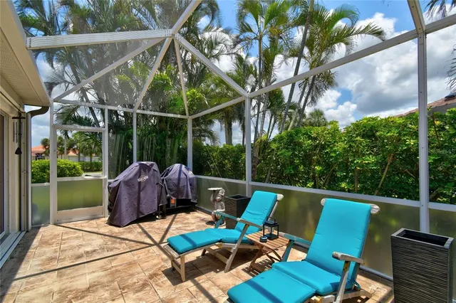 a view of a patio with table and chairs potted plants with wooden floor and fence